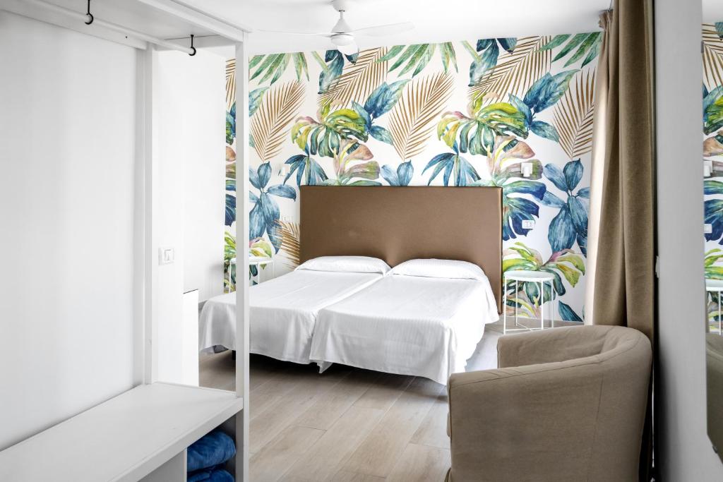 a bedroom with a bed with a tropical wallpaper at Hotel Valencia in Las Palmas de Gran Canaria