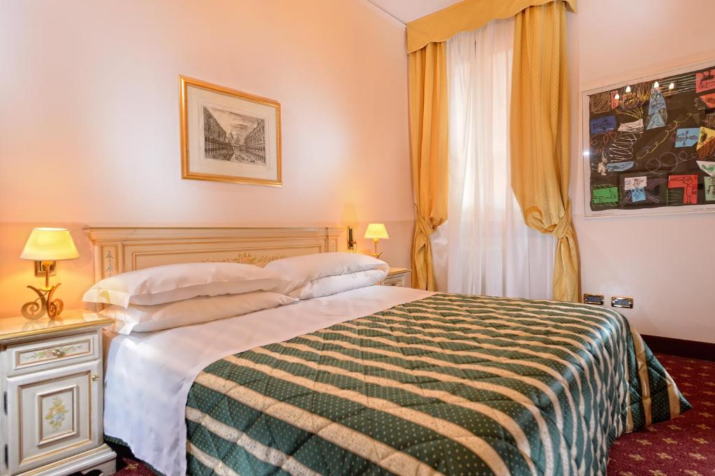 a hotel room with a bed and a window at Albergo Cavalletto &amp; Doge Orseolo in Venice
