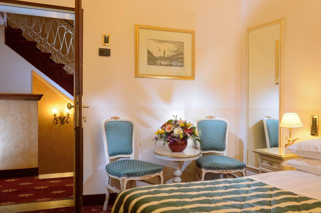 Postel nebo postele na pokoji v ubytování Albergo Cavalletto & Doge Orseolo