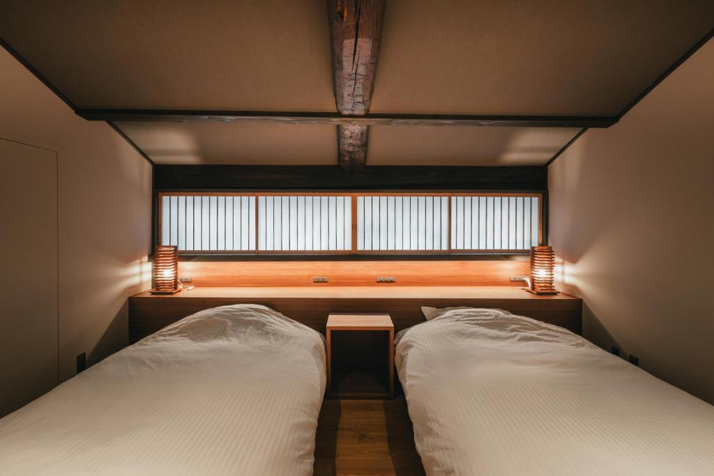 Postel nebo postele na pokoji v ubytování まほろ松江