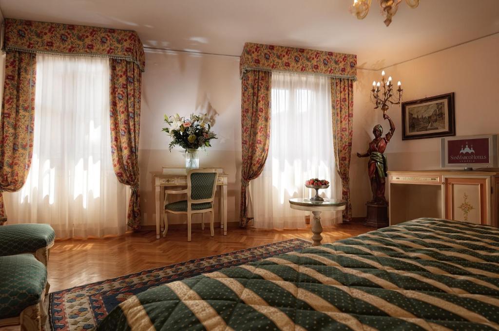 Postel nebo postele na pokoji v ubytování Albergo Cavalletto & Doge Orseolo