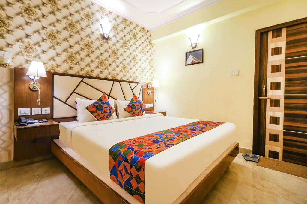 um quarto com uma cama grande num quarto em FabHotel Magadh Palace em Patna