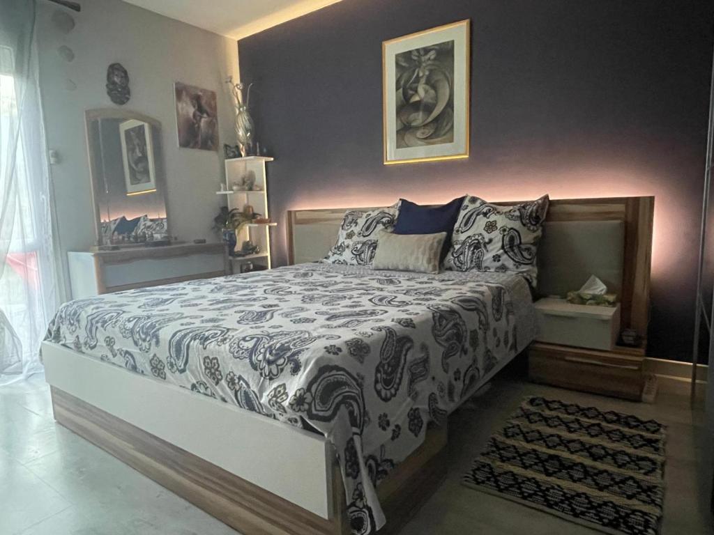 ein Schlafzimmer mit einem Bett mit einer schwarz-weißen Bettdecke in der Unterkunft Charmante maison pour vos vacances in La Rochelle