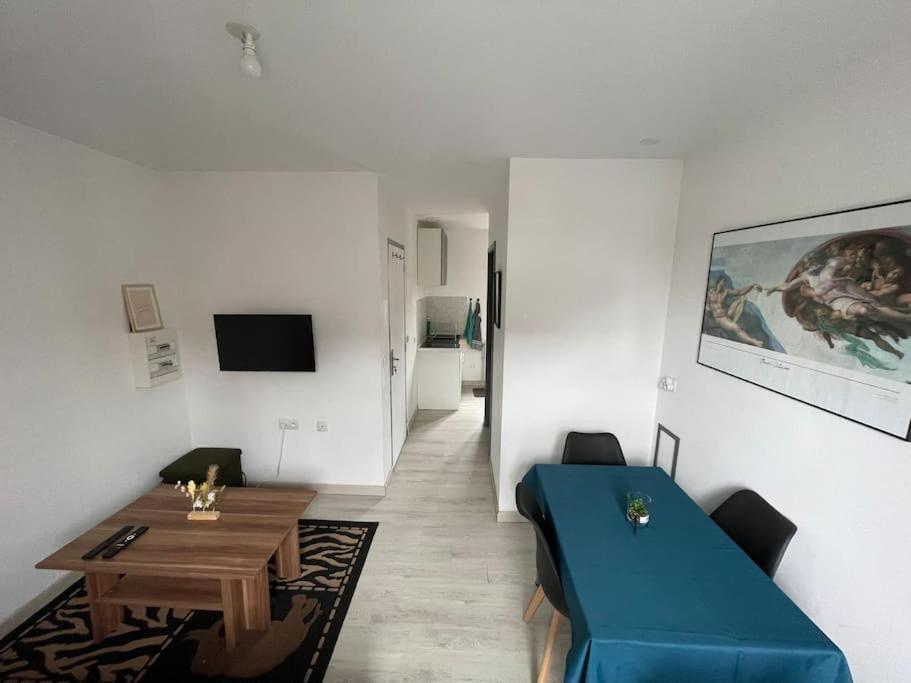 un salon avec un canapé bleu et une table dans l'établissement Proche Citadelle & Quartier Saint-leu, à Amiens