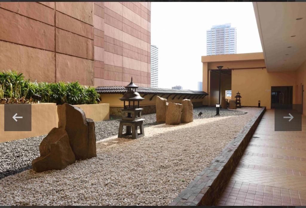 a walkway in a building with rocks on the ground at Grand Riviera Suites in Manila