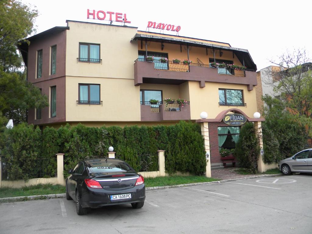 a car parked in a parking lot in front of a hotel at Hotel Diavolo in Sofia