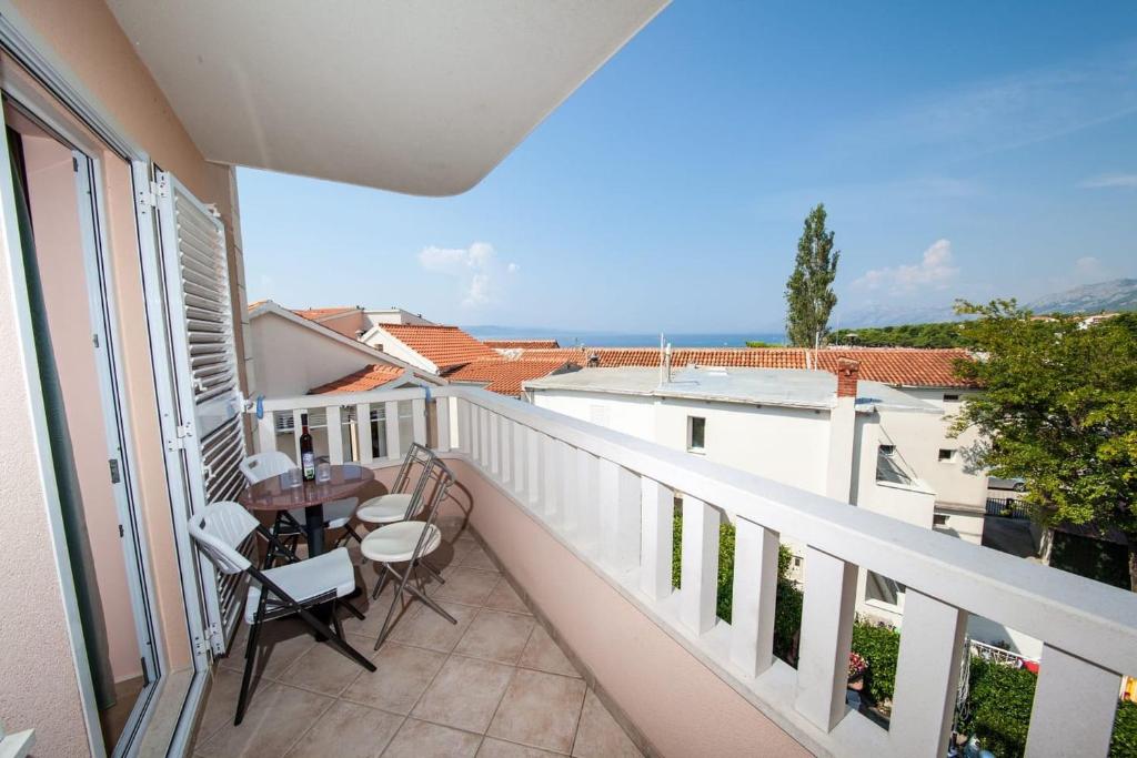 a balcony with a table and chairs and a view of the ocean at Vila Promajna 3 in Promajna