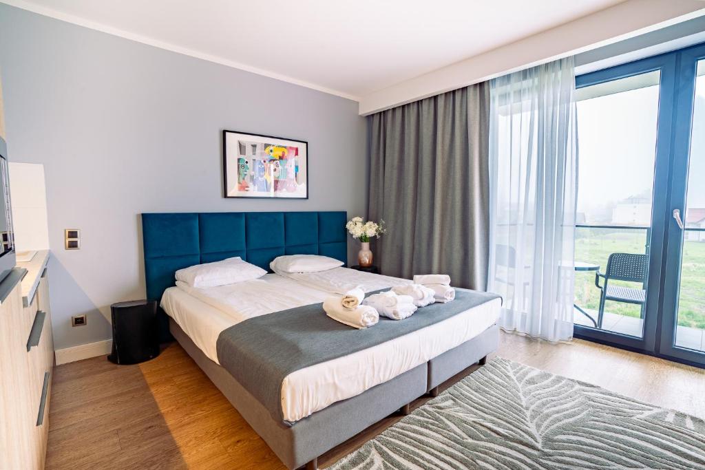 Postel nebo postele na pokoji v ubytování Mielenko & Spa ex Baltin Hotel