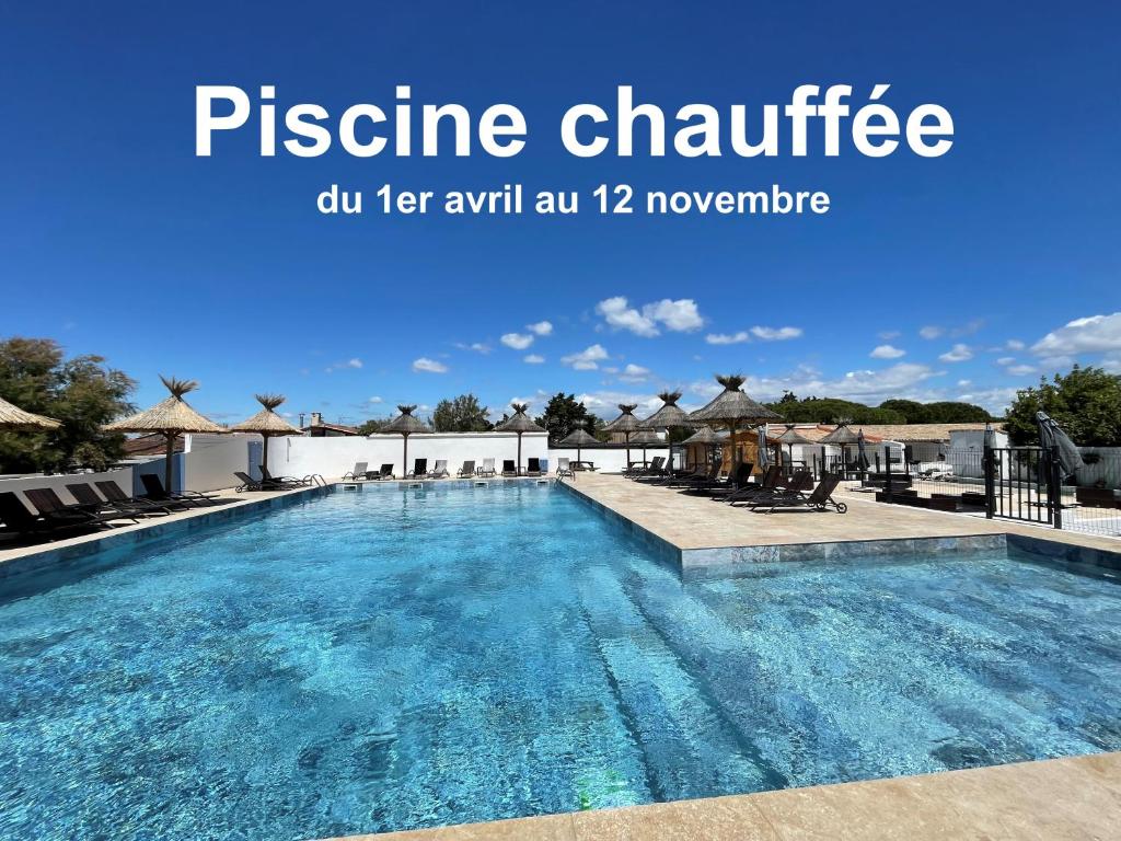 an image of a swimming pool at a resort at Hotel Mas des Lys in Saintes-Maries-de-la-Mer