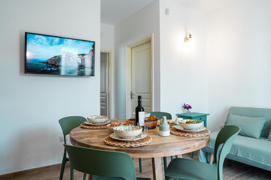 a dining room with a table and chairs and a couch at La Casa al mare Torre San Giovanni in Torre San Giovanni Ugento