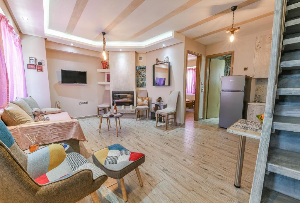 a living room filled with furniture and a fireplace at AGALI HOUSE in Limenaria