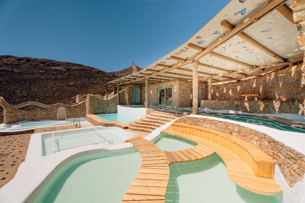 a resort with a swimming pool with a bridge at Calilo in Manganari