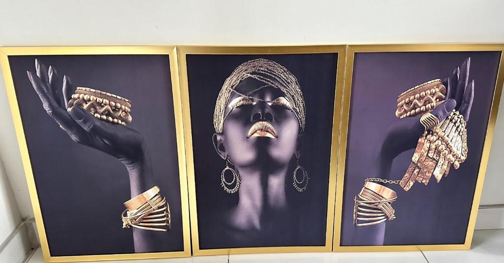 a framed picture of a woman with jewelry on it at The legacy BnB in East London