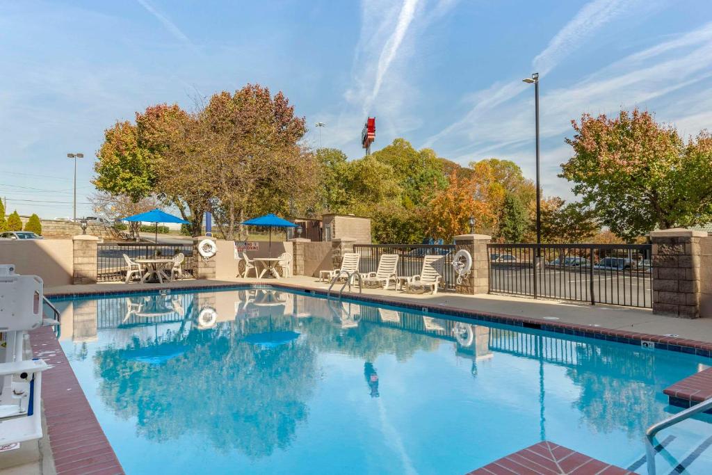 a large swimming pool with chairs and umbrellas at Comfort Inn Greensboro - Kernersville in Greensboro