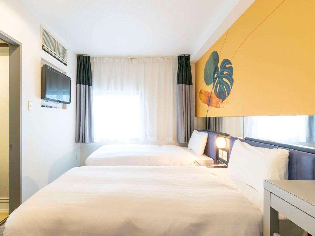 Postel nebo postele na pokoji v ubytování Comfort Inn Naha Tomari Port