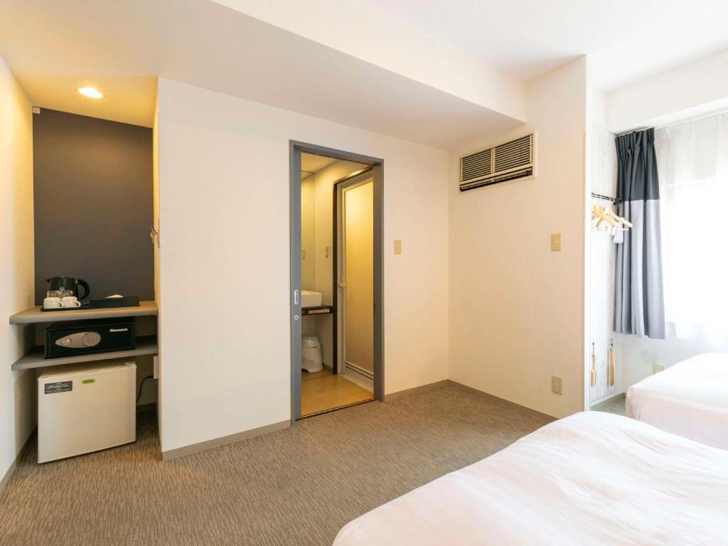 Postel nebo postele na pokoji v ubytování Comfort Inn Naha Tomari Port