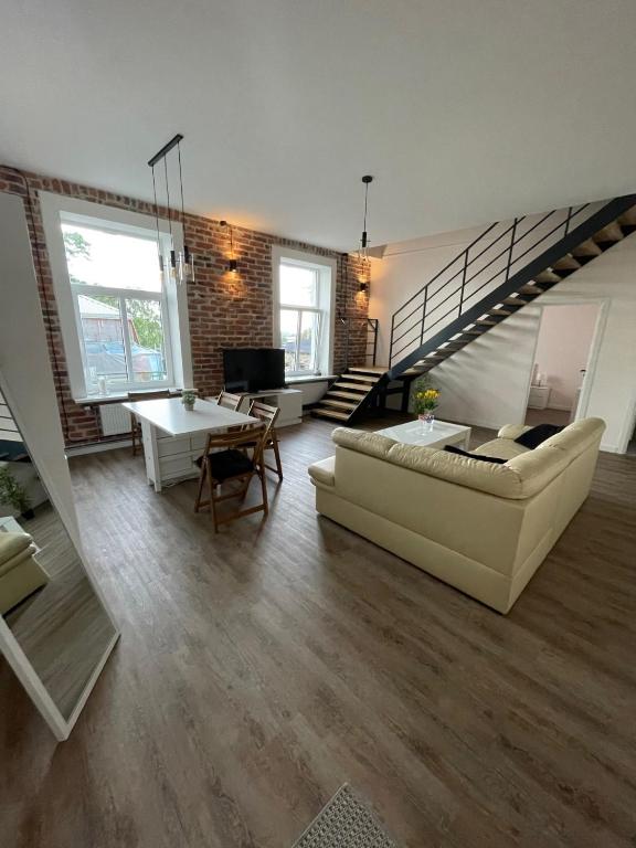 a living room with a couch and a table at Dream Apartment in Liepāja