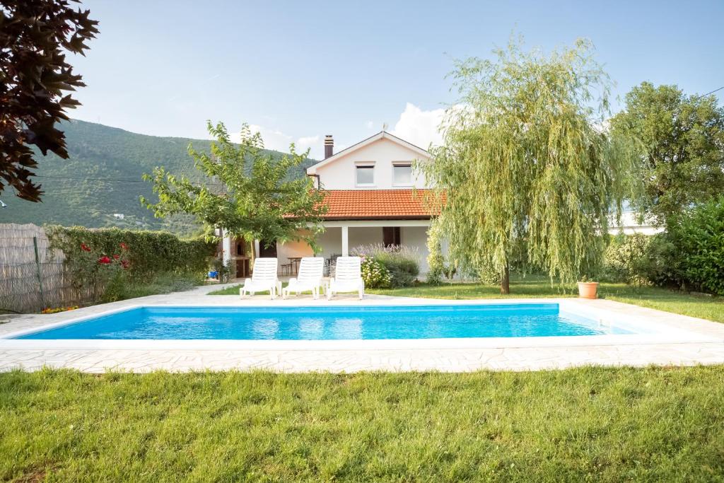 a swimming pool in the yard of a house at Holiday Home Vemini in Mostar