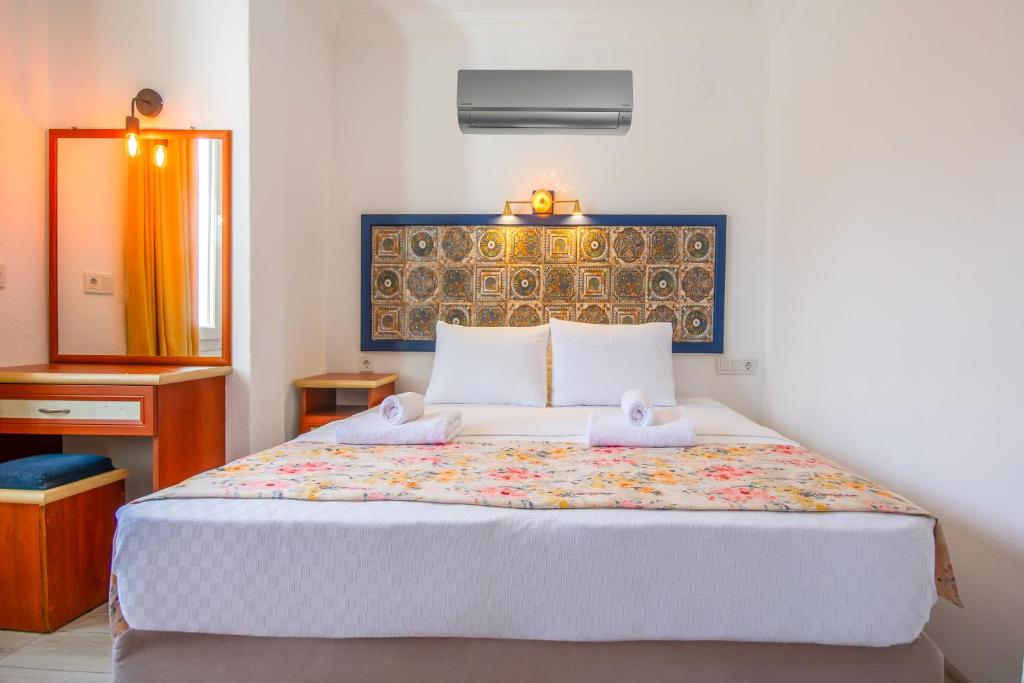 Postel nebo postele na pokoji v ubytování Özgüm Suite Otel