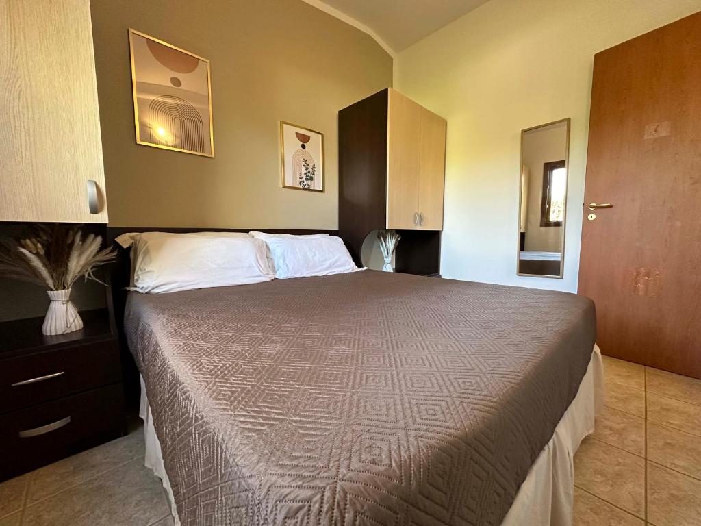 A bed or beds in a room at Holiday Apartment orchidea with swimming pool and private beach -3