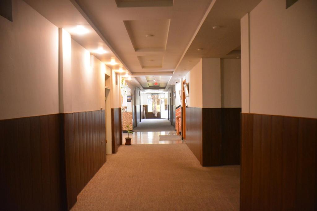 a hallway in a building with a long corridor at Besham Inn, Besham in Besham