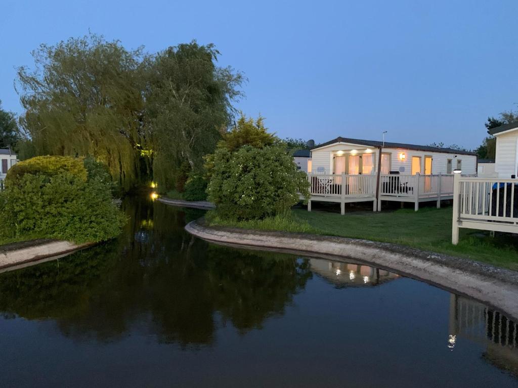 a view of a river at night with houses at 29 Morningside at Southview in Skegness - Park Dean resorts in Lincolnshire