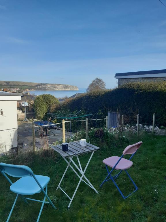 a table and two chairs and a table and chairs at Marlow in Swanage