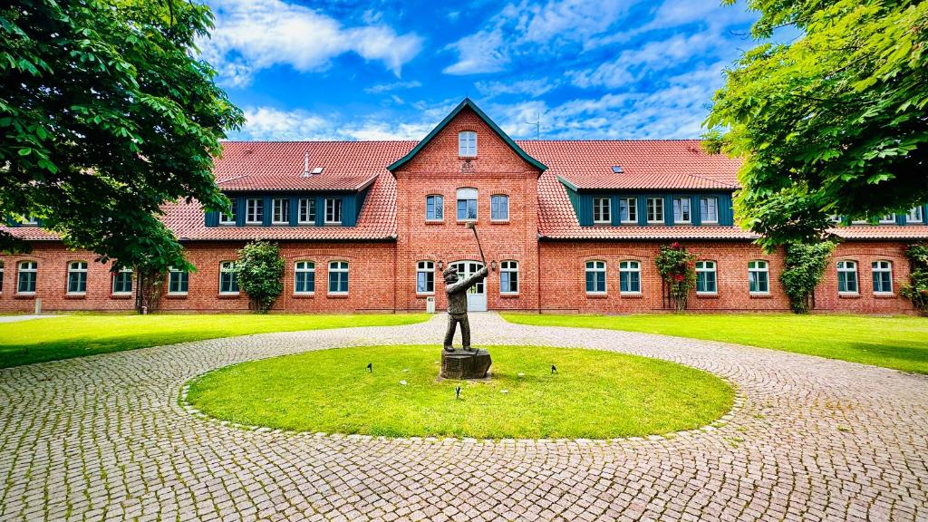 a building with a statue in front of it at Schloss Lüdersburg Golf & Spa in Lüdersburg