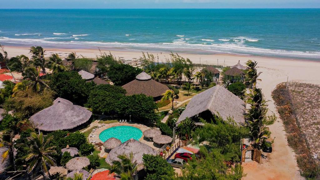 Ocas do Índio Hotel Spa في بيبيريبي: اطلالة جوية على منتجع مع شاطئ