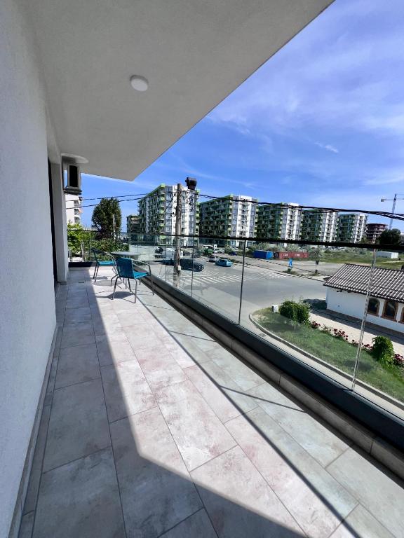 a balcony with a view of a street and buildings at Sea Panorama Apartments & Free Parking in Năvodari
