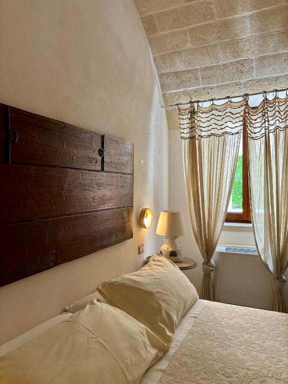 Postel nebo postele na pokoji v ubytování I Trulli del Tupparello