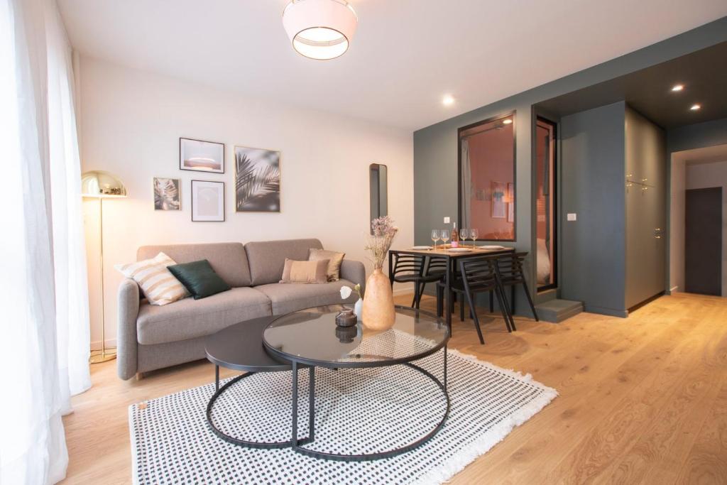 un salon avec un canapé et une table dans l'établissement GuestReady - Apt near Parc de la Villette, à Paris