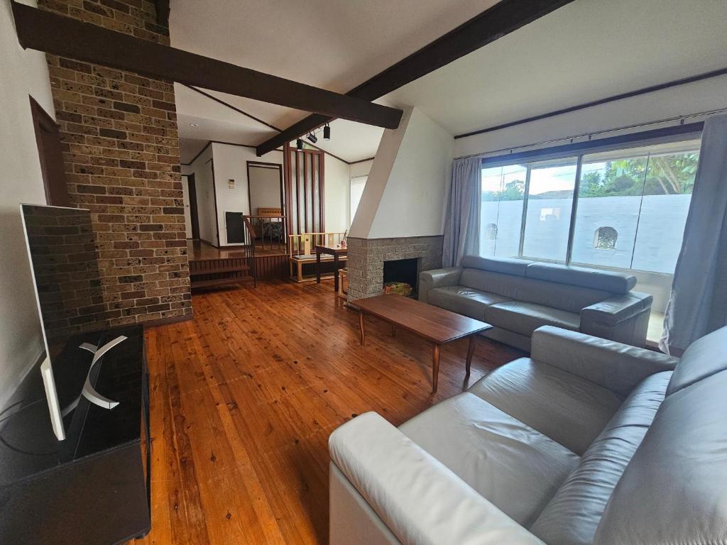 a living room with a couch and a fireplace at Entire 3 bedroom personal house in Chipping Norton in Chipping Norton