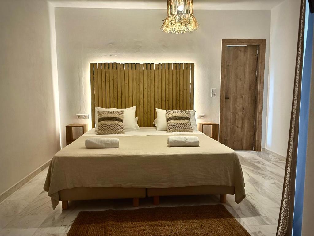 a bedroom with a large bed with a large mirror at Athina Rooms - Lounge Apartments in Parikia