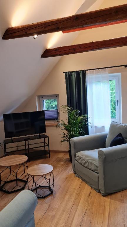 a living room with a couch and a flat screen tv at CHILL&SLEEP Bad Ischl in Bad Ischl