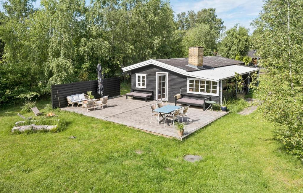 a small cabin with a deck in a yard at Nice Home In Sjællands Odde With Wifi in Yderby