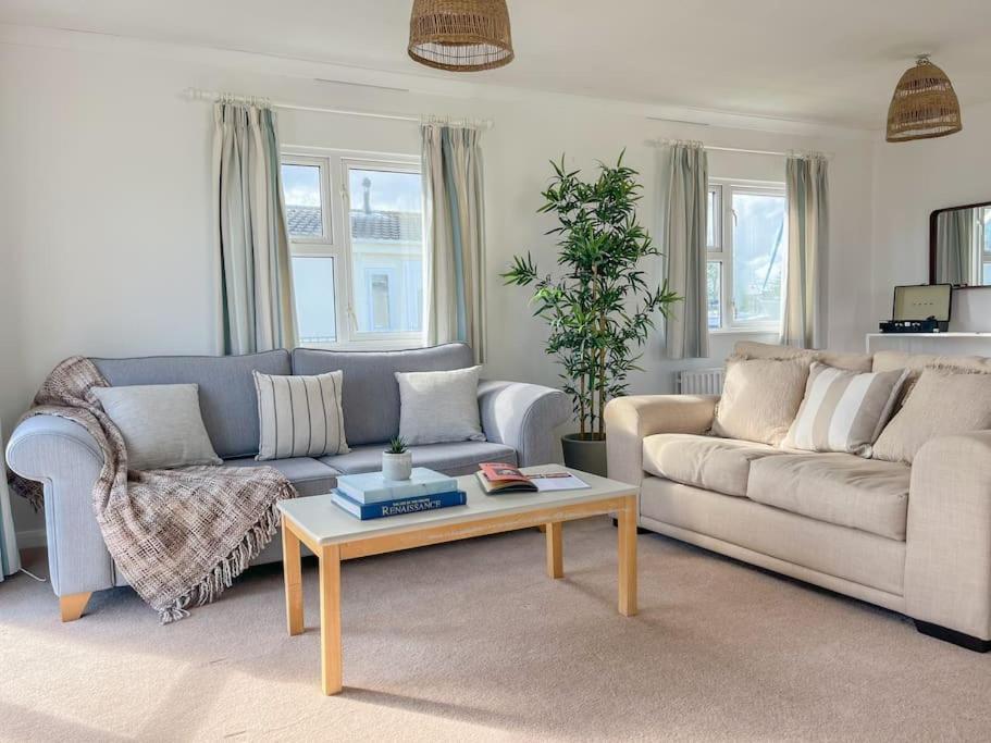 a living room with a couch and a coffee table at Tranquil Riverside Lodge in Christchurch