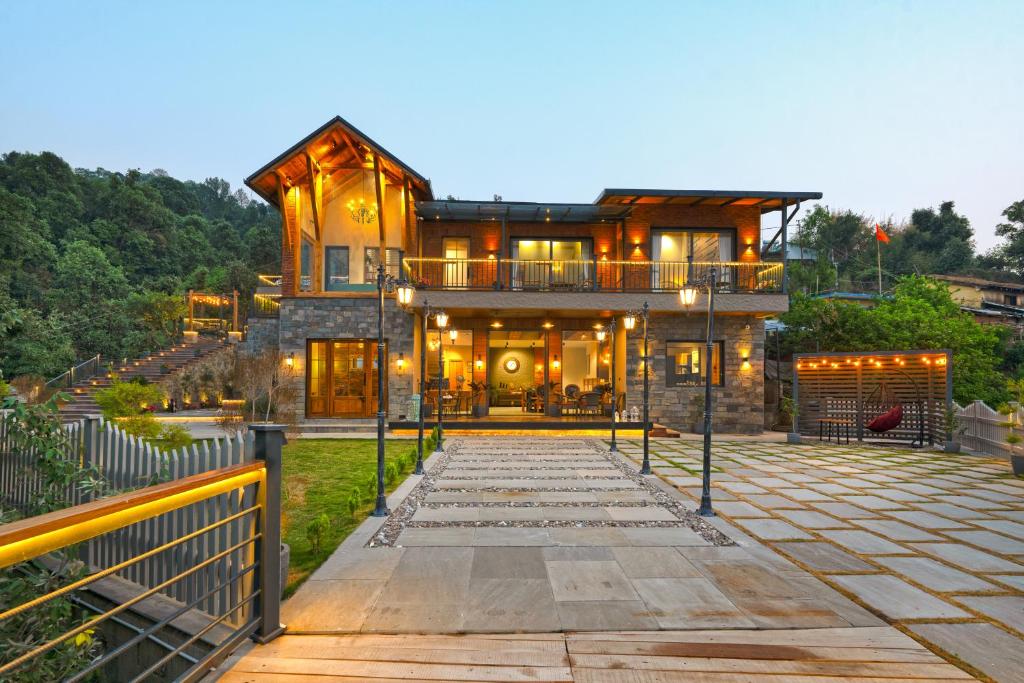 a house with a walkway in front of it at SaffronStays Aruunoday - 4BR with Theatre, Deck & Bonfire in Bhīm Tāl