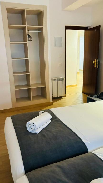 Postel nebo postele na pokoji v ubytování Hostal Sans