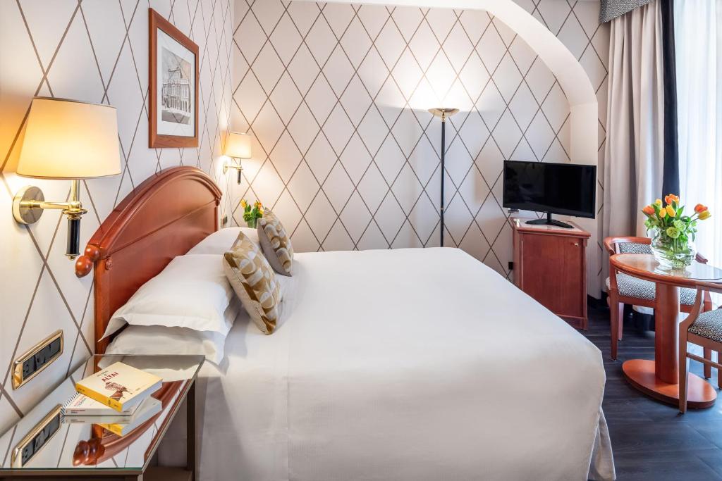 Un pat sau paturi într-o cameră la Starhotels Majestic