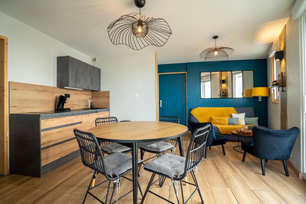 a kitchen and dining room with a table and chairs at Appartement LES PIEDS DANS L'EAU in Saint-Gilles-Croix-de-Vie
