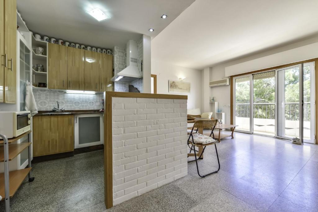 a kitchen and dining room with a brick wall at Apartment Sunset Moraira City in Moraira