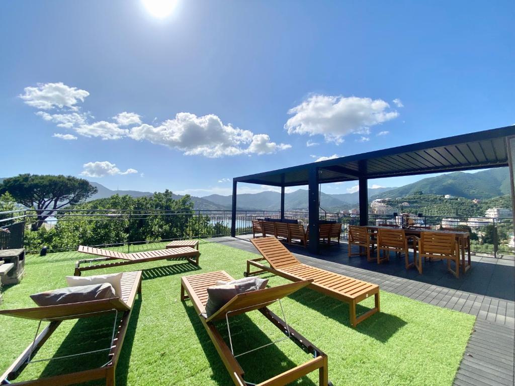 a group of chairs and tables on a roof at CasaViva - Terrace Apt with Parking in Rapallo in Rapallo