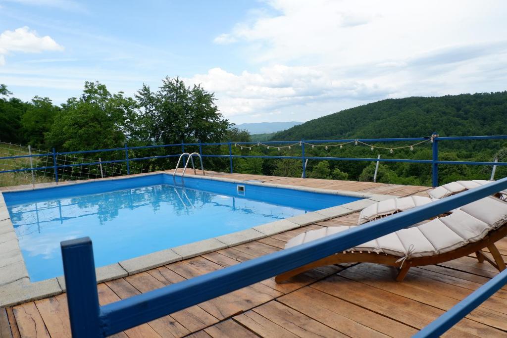 een zwembad op het terras van een huis bij Bosnian Mountain Retreat in Prijedor