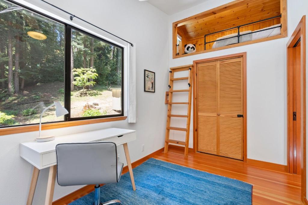 a home office with a desk and a window at Redwood Oasis - Eco-luxury cabin with hot tub in the Santa Cruz Mountains in Ben Lomond