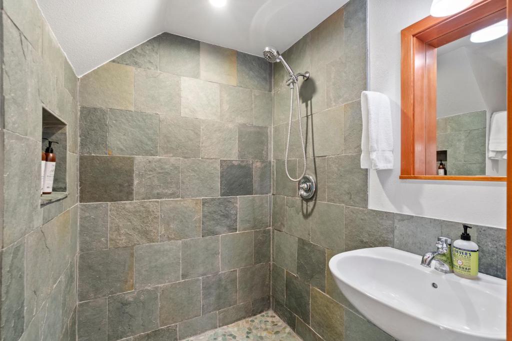a bathroom with a sink and a shower at Redwood Oasis - Eco-luxury cabin with hot tub in the Santa Cruz Mountains in Ben Lomond