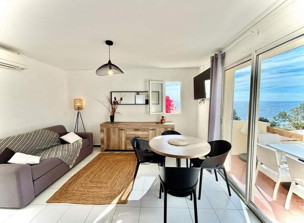 a living room with a couch and a table at LoVe 2 in Cap d&#39;Agde