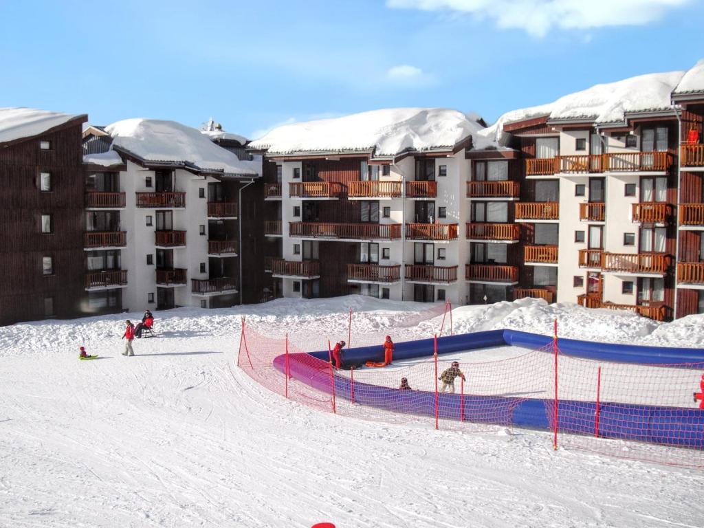 a group of people skiing in the snow in front of a hotel at Studio a La Plagne Tarentaise a 300 m des pistes avec balcon amenage et wifi in La Plagne Tarentaise