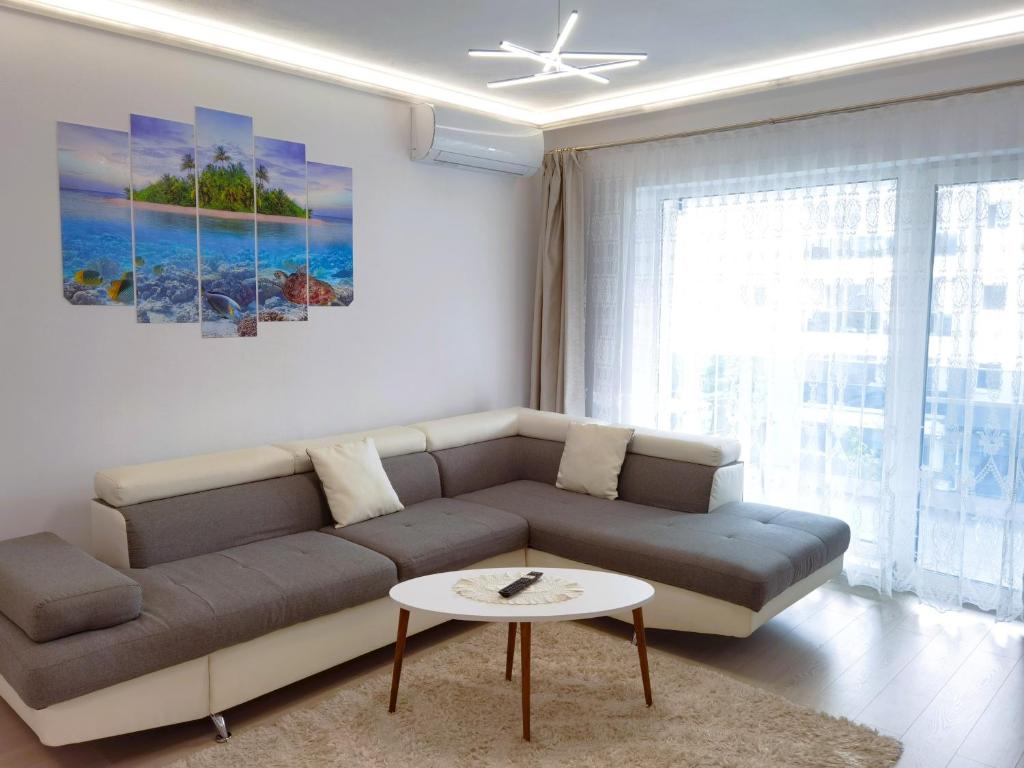 a living room with a couch and a table at Select Apartment SIBIU in Sibiu