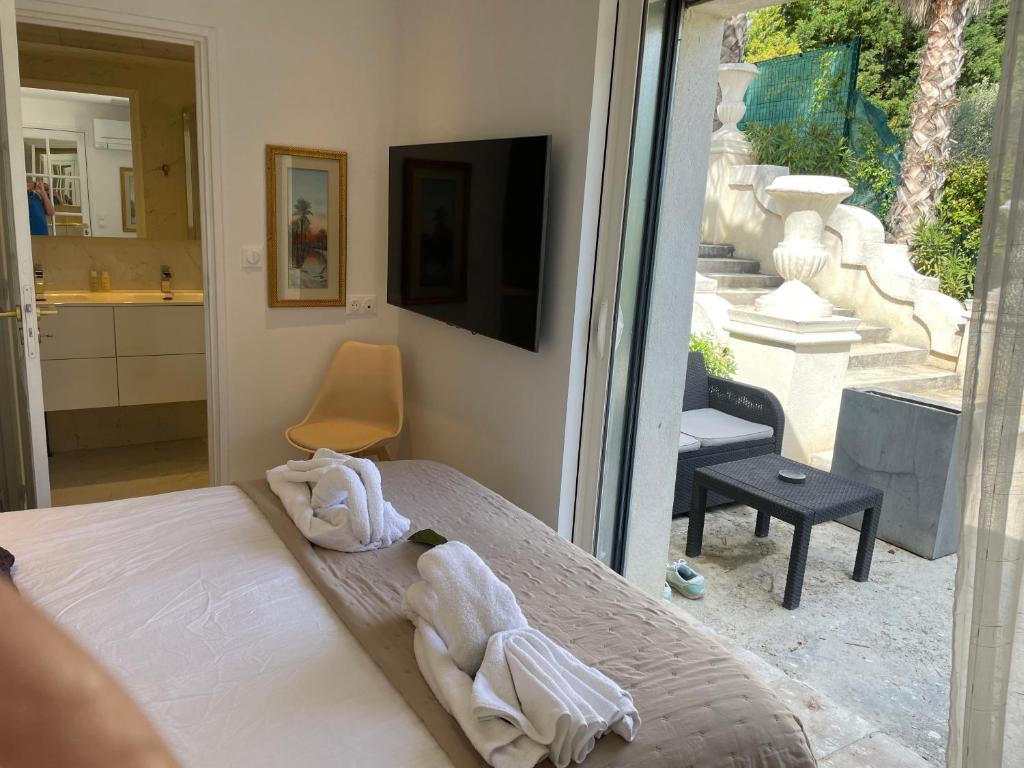 a bedroom with a bed and a sliding glass door at Maison Blue Palm Aix en Provence in Aix-en-Provence